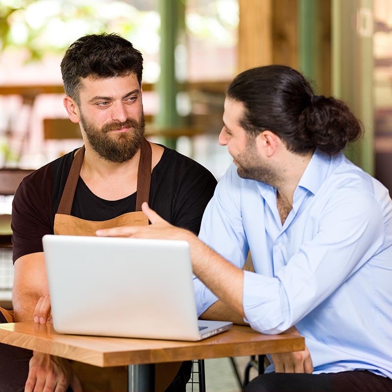Two men in a meeting at a coffee shop