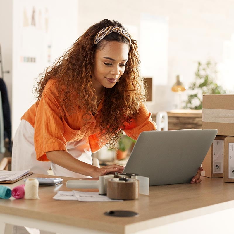 Young woman working with clothes inventory in a store